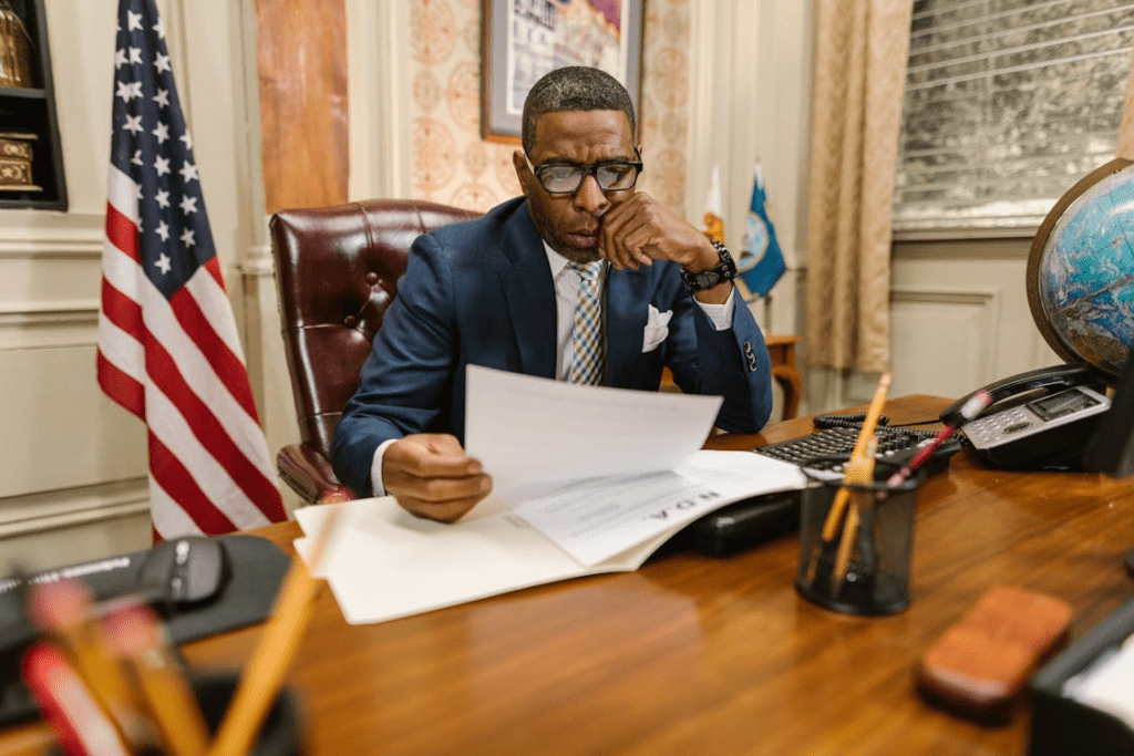 Law firm partner reviewing attorney candidate resumes during the hiring process